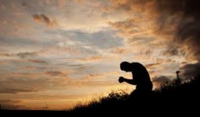 A faithful man on his knees praying for regeneration.